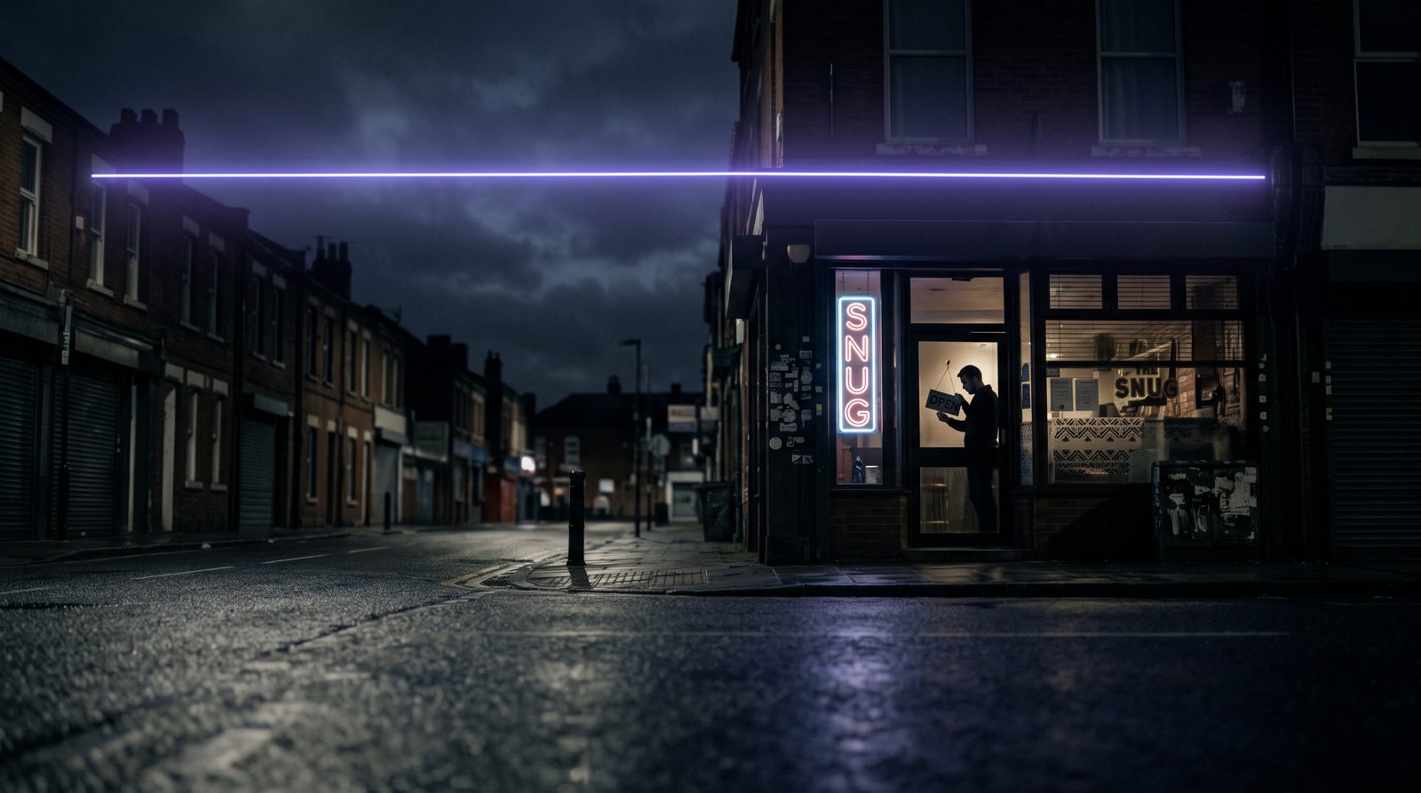 A Main Street storefront glowing warm at dusk under a thin violet horizon line